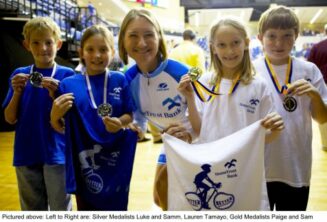 Lauren Tamyo poses with local children.