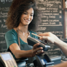 Young woman taking a mobile payment.