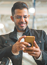 Man smiling using a cell phone