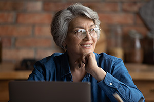 woman smiling using a laptop