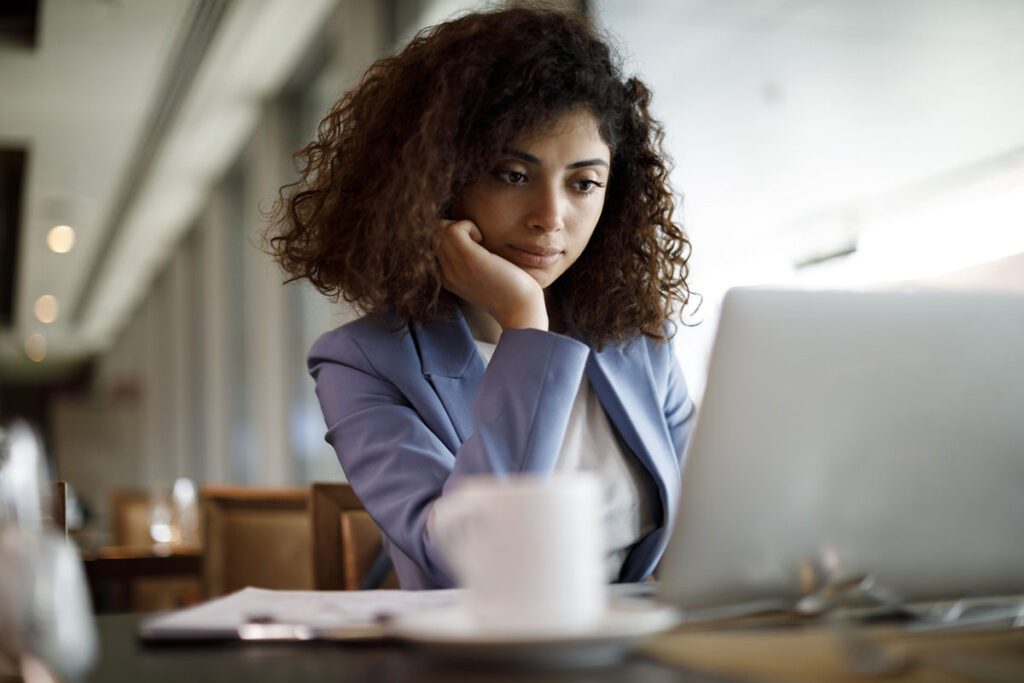 Businesswoman working on laptop at a cafe