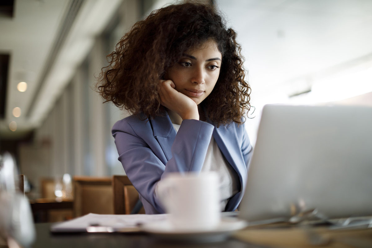 Businesswoman working on laptop at a cafe