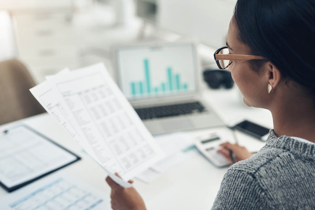 Closeup shot of an unrecognisable businesswoman calculating finances in an office.
