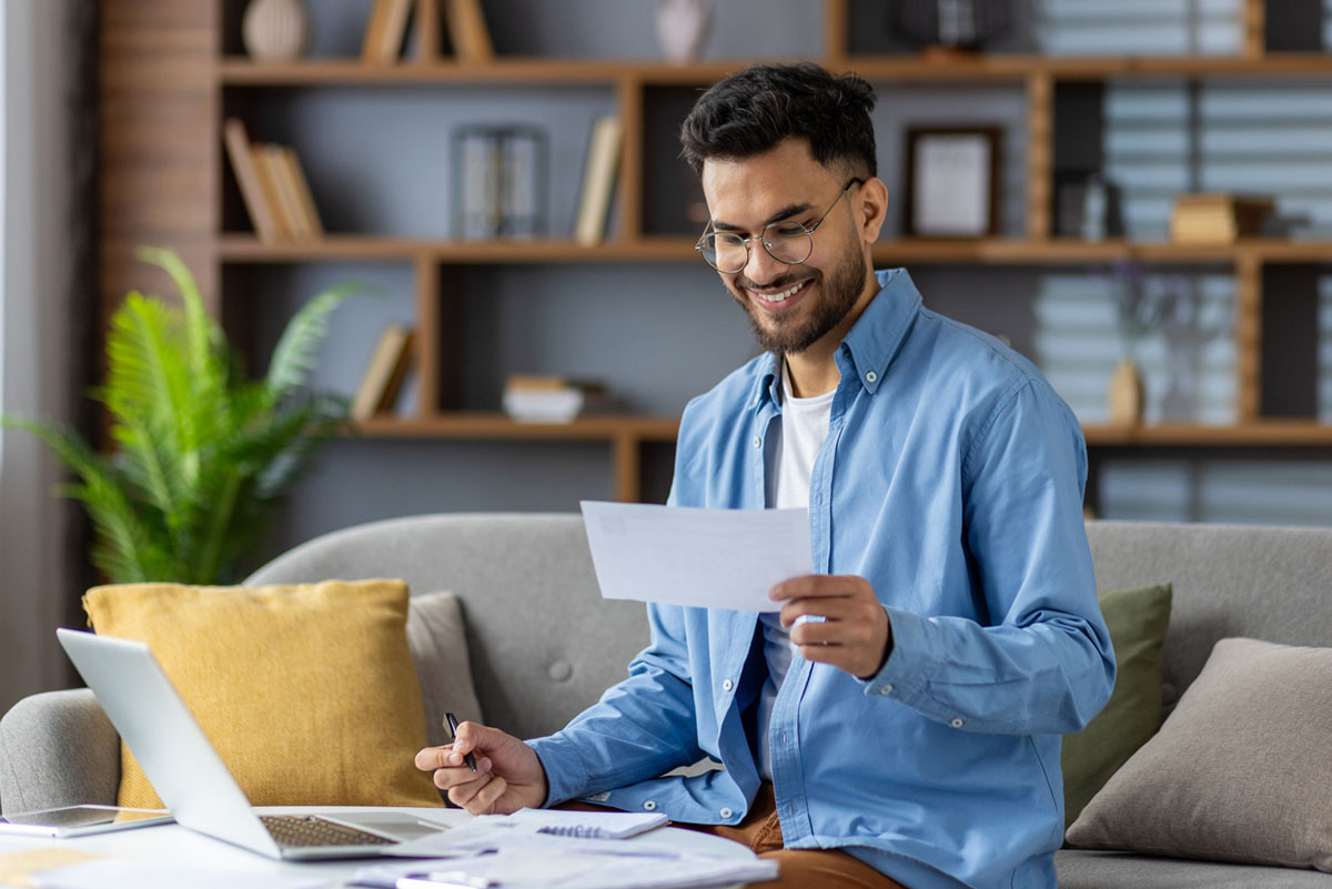 Man managing finances in a living room